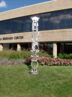 Stacked metal sculpture of different shapes.